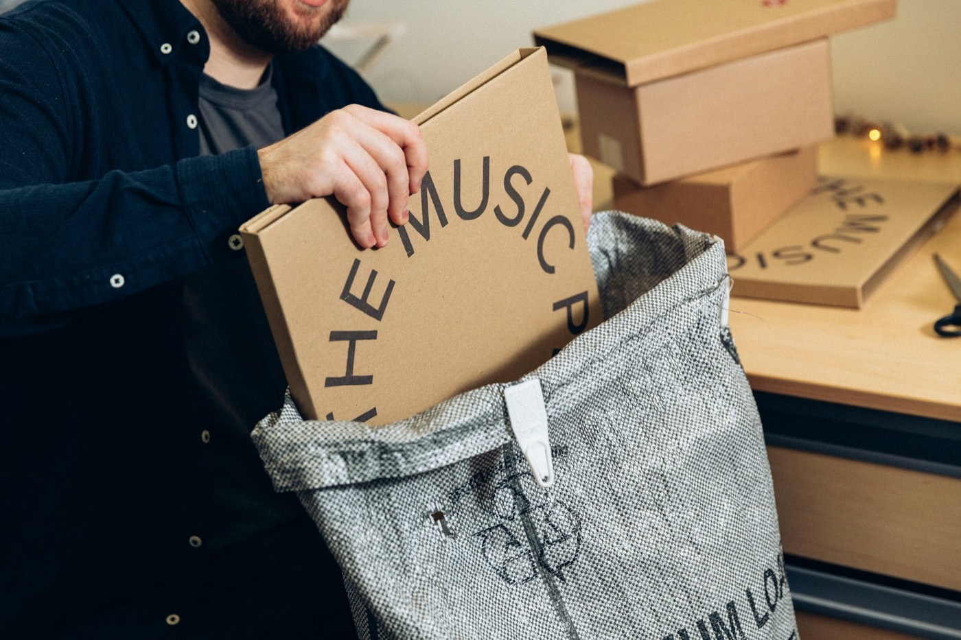 A small ecommerce business owner packing a customer order